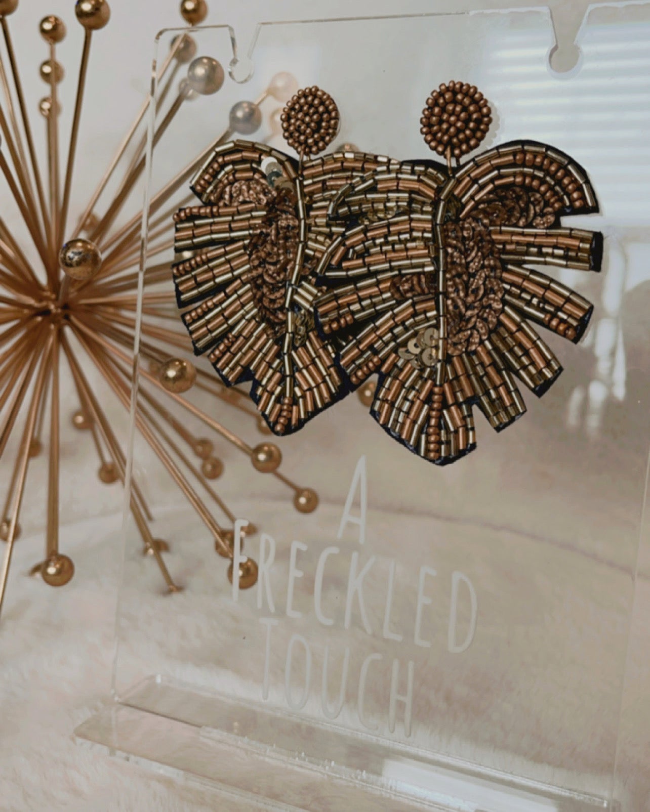 Gold palm earring